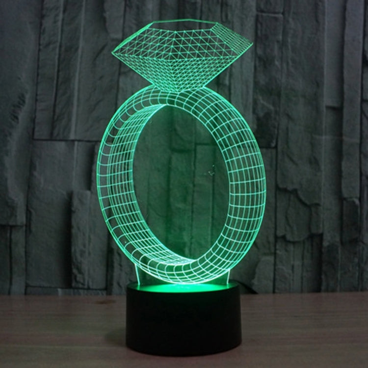 Diamond-ring LED desk lamp glowing green with diamond top and oval ring