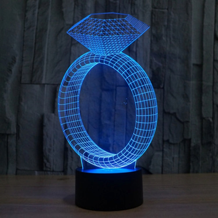 Diamond-ring LED desk lamp glowing blue with diamond top and oval ring