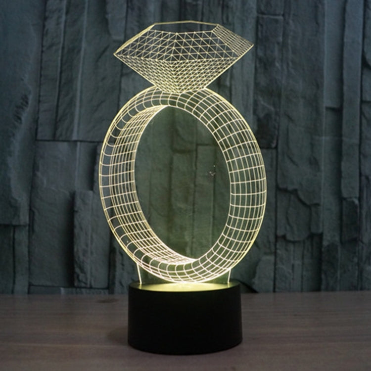 Diamond-ring LED desk lamp glowing gold with diamond top and oval ring