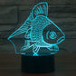 Goldfish-style desk lamp with glowing teal fish silhouette and black base