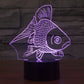 Goldfish-style desk lamp with glowing purple fish silhouette and black base