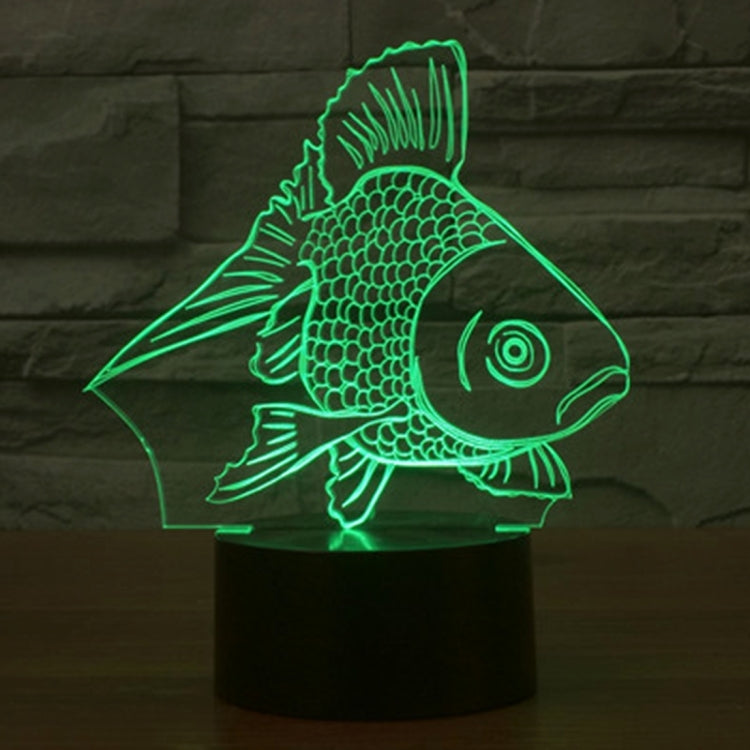 Goldfish-style 3D desk night light glowing green fish on a black cylinder base