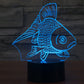 Goldfish-style 3D desk night light glowing blue fish on a black cylinder base