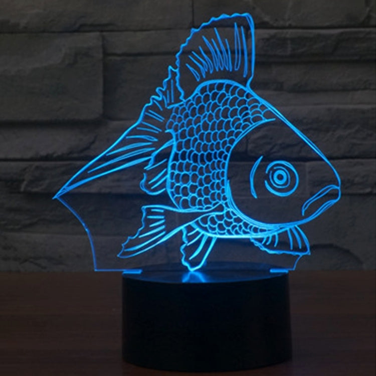 Goldfish-style 3D desk night light glowing blue fish on a black cylinder base