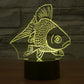 Goldfish-style 3D desk night light glowing yellow fish on a black cylinder base