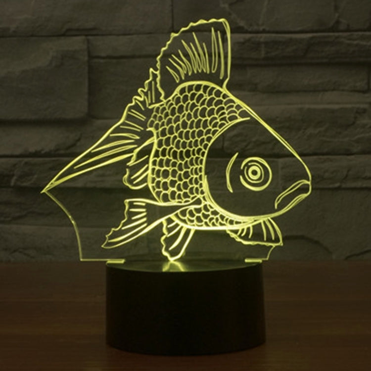 Goldfish-style 3D desk night light glowing yellow fish on a black cylinder base