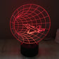 Time machine style desk lamp with red grid globe and airplane light on black base