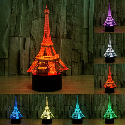 Color-changing Eiffel Tower LED desk lamp, glowing orange and purple with black base
