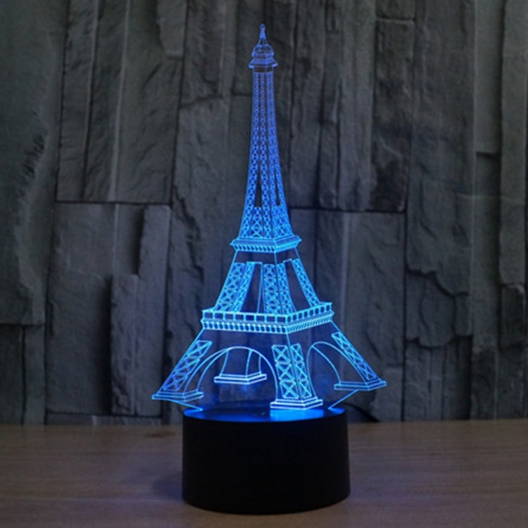 Eiffel Tower desk night light with blue glowing tower and black round base