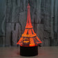 Eiffel Tower LED desk lamp glowing red-orange on black base