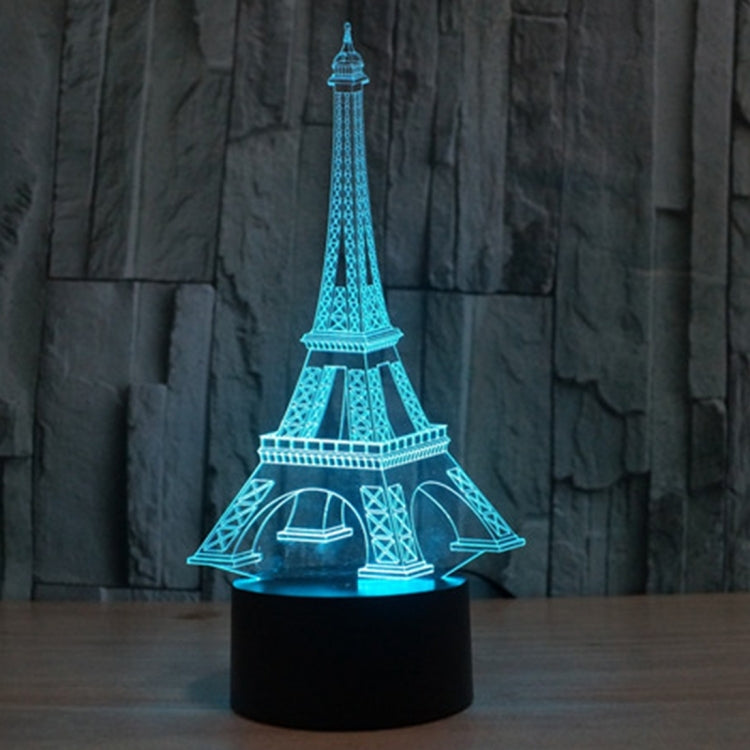 Eiffel Tower LED desk lamp glowing blue on black base