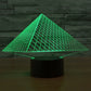 Pyramid LED desk lamp with glowing green triangular grid over black base
