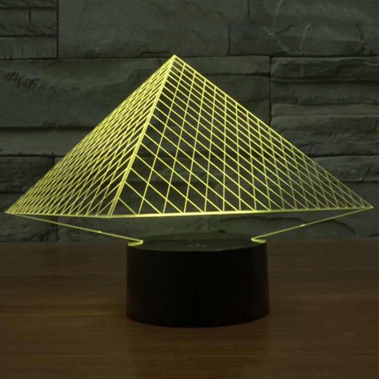 Pyramid LED desk lamp with glowing yellow triangular grid over black base