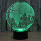 Green-lit globe desk lamp showing world map lines on a black base