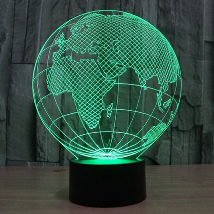 Green-lit globe desk lamp showing world map lines on a black base