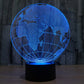 Blue-lit globe desk lamp showing world map lines on a black base