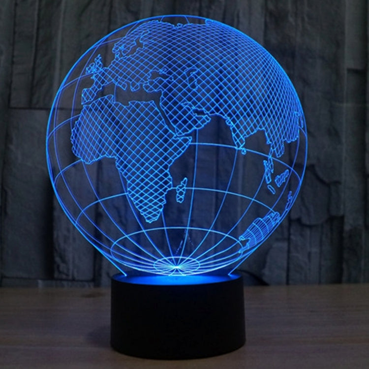 Blue-lit globe desk lamp showing world map lines on a black base