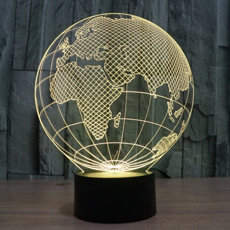 Gold-lit globe desk lamp showing world map lines on a black base