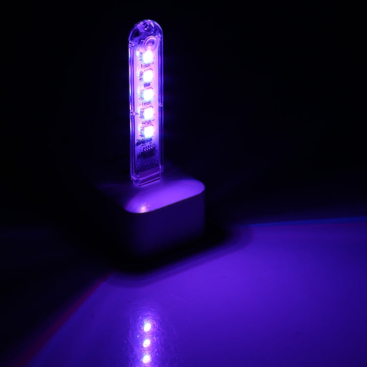 USB LED night light glowing purple-blue with 5 LEDs through clear casing