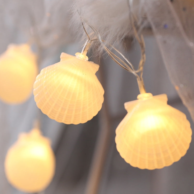 Shell-shaped fairy string lights with warm glow LED bulbs on clear wire