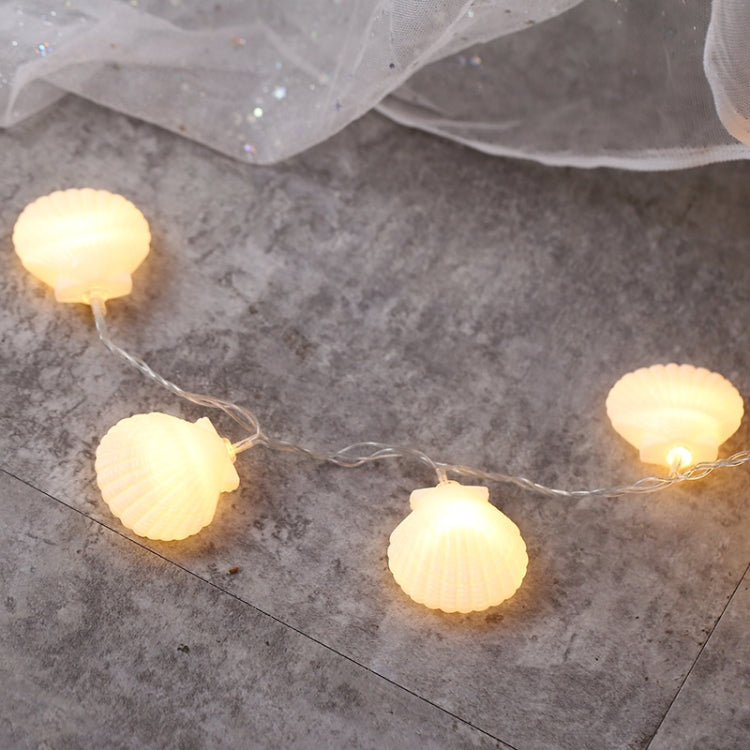 Warm shell LED fairy lights strung across clear wire with small glowing bulbs