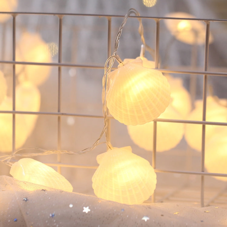 Warm shell-shaped LED fairy lights hanging on thin wire