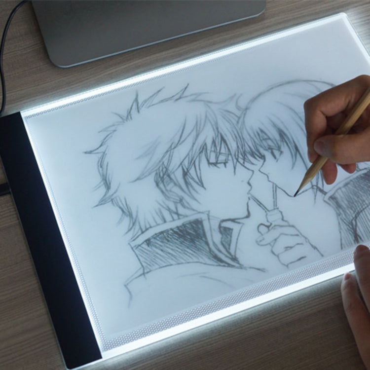 A4 USB LED tracing light box with illuminated white panel for sketching, pen in use