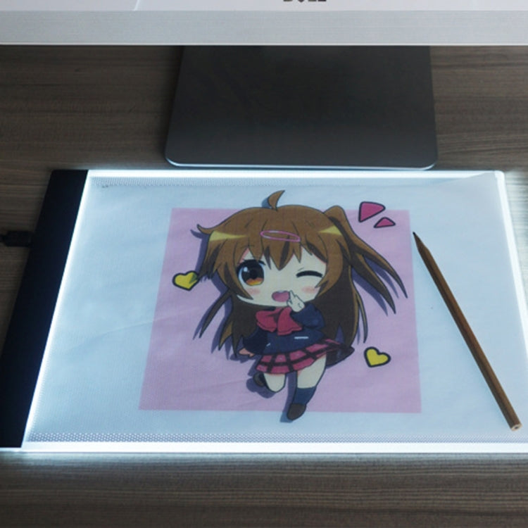 A4 USB LED tracing light box showing character art on lit panel with pencil
