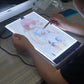 Portable A4 LED tracing light box, artist painting over backlit illustration