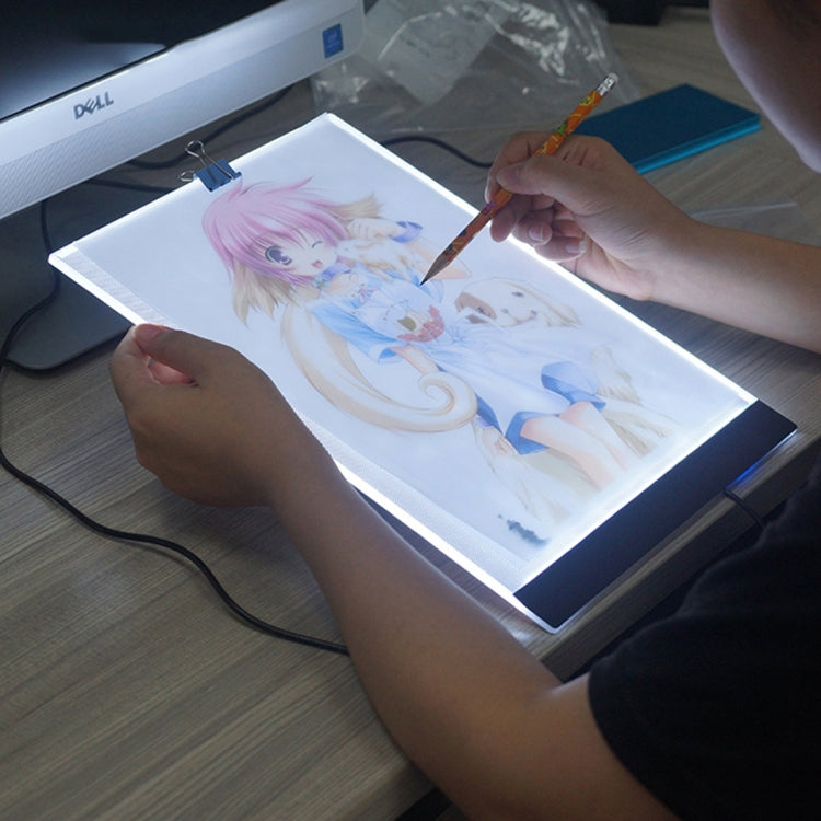 Portable A4 LED tracing light box, artist painting over backlit illustration