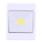 Square white LED wall light with clear lens and centered yellow LED indicator