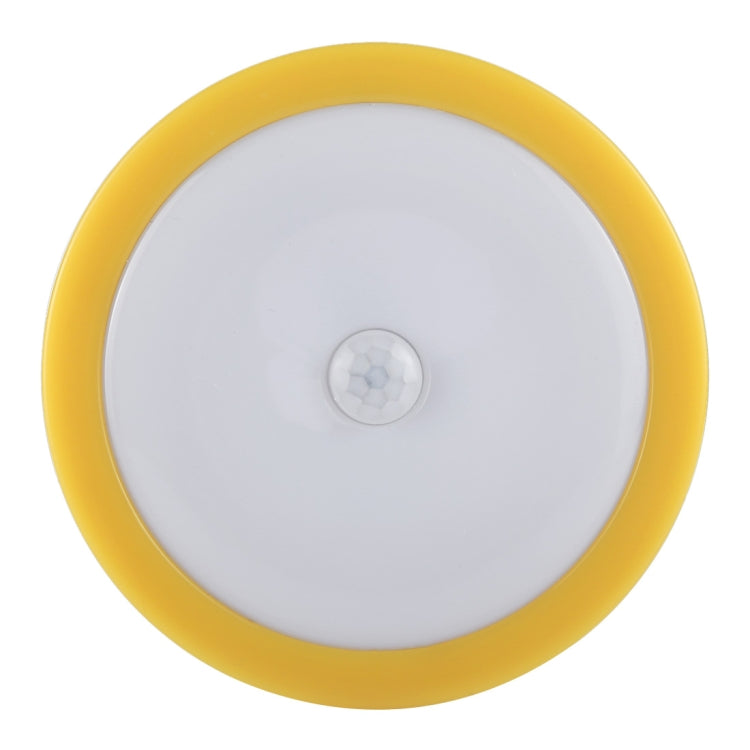 Round LED cabinet emergency light with white body, yellow ring, and front motion sensor