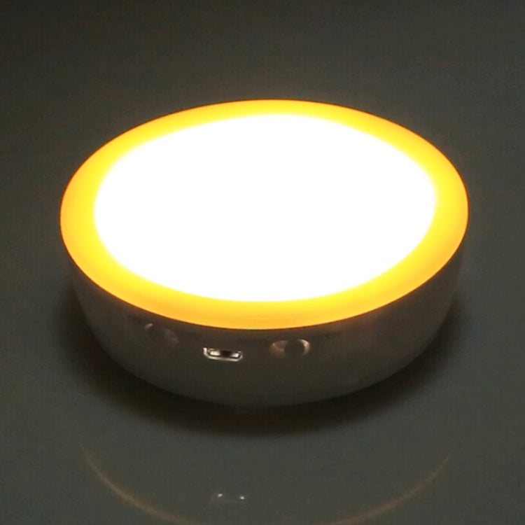 Glowing round LED cabinet emergency light with yellow rim, bright warm white light