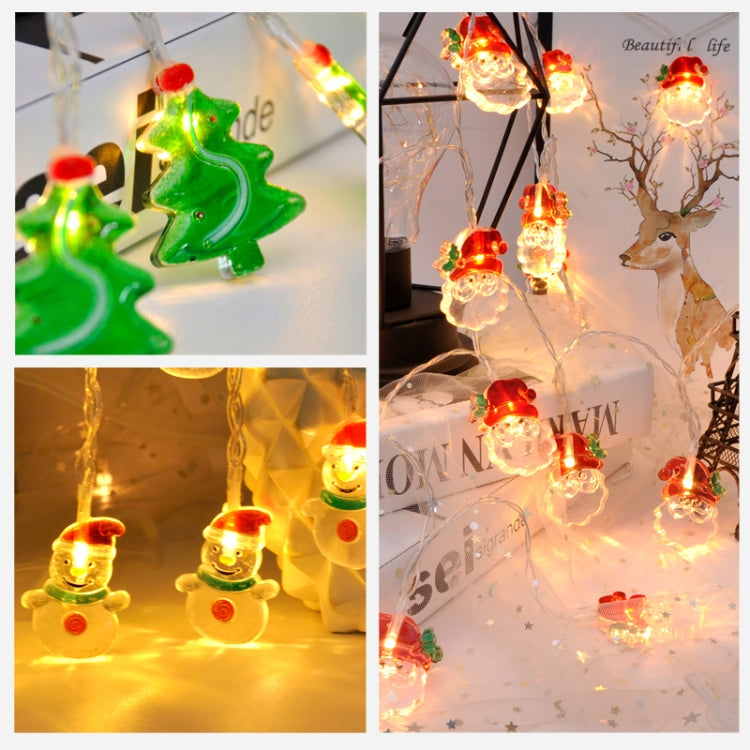 LED light string close-up of green tree and warm glowing snowman ornaments