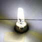 Lit G4 COB LED corn bulb with two metal pins and round base, bright white light