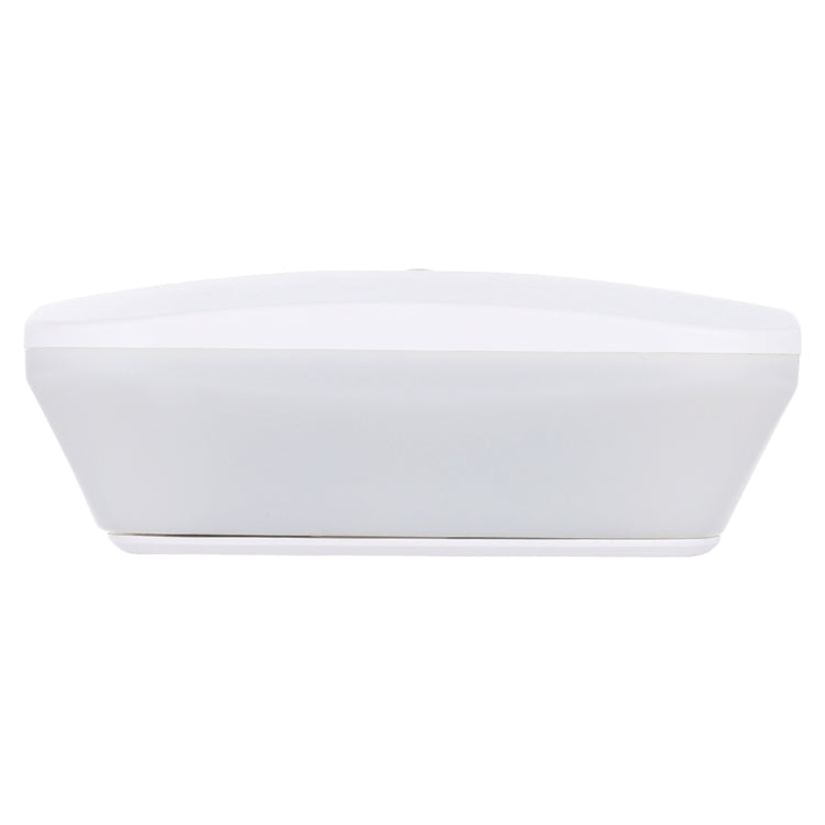White low-profile LED sensor light housing for wall or ceiling mounting