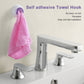Self-adhesive towel hook holding a pink towel with a purple insert