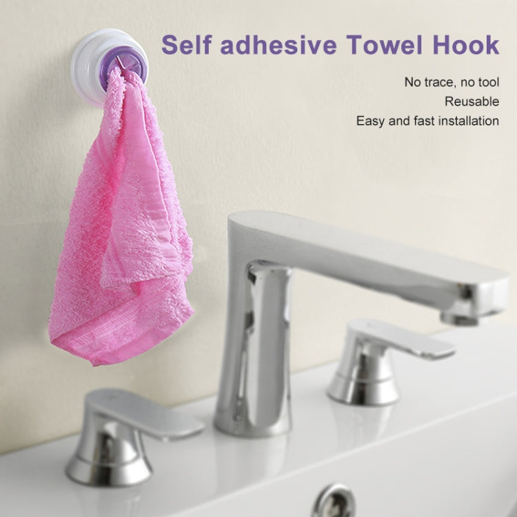 Self-adhesive towel hook holding a pink towel with a purple insert