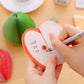 Watermelon note sticker being written on by hand, showing orange edge and black lines