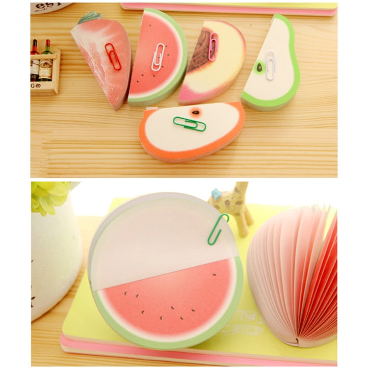 Assorted fruit note stickers laid on a wooden desk, including watermelon and pear shapes