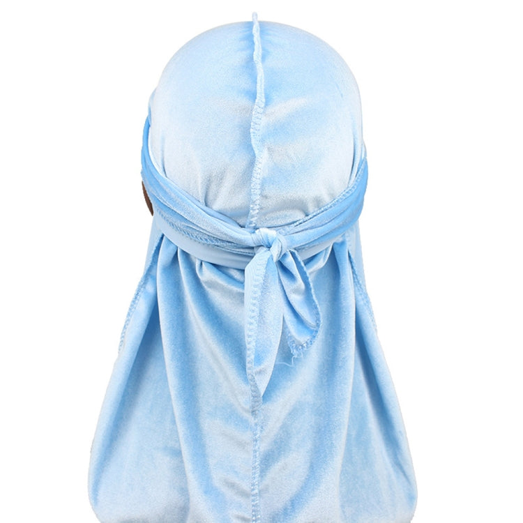 Light blue velvet turban cap with tied back and long trailing drape