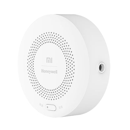 Round smart gas alarm sensor with perforated speaker grille and side outlet port