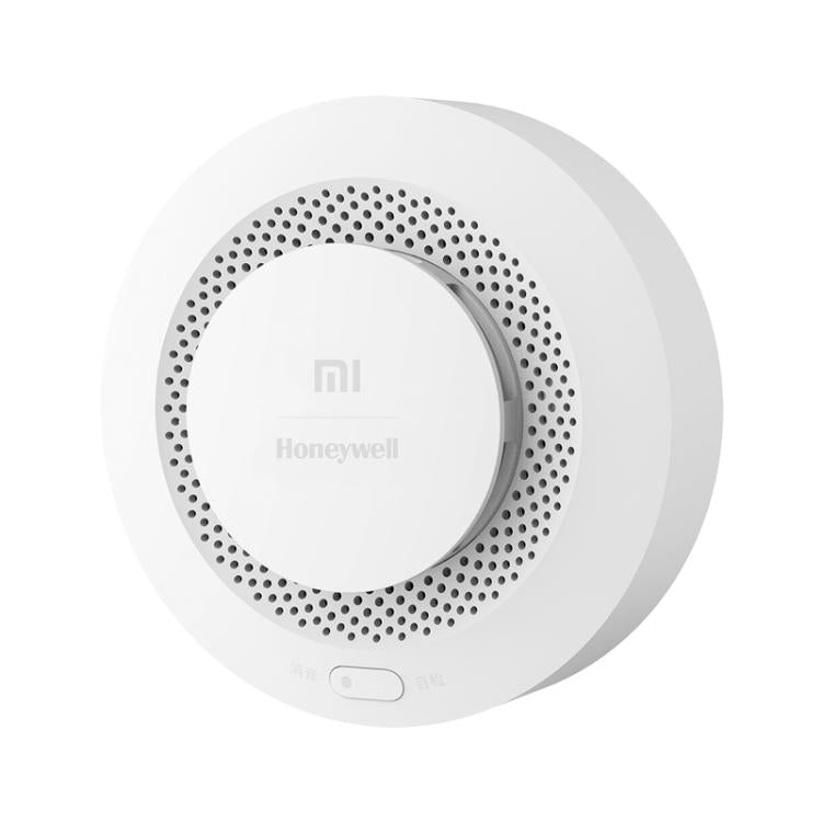 White circular smoke alarm detector with recessed center and perforated outer speaker grille