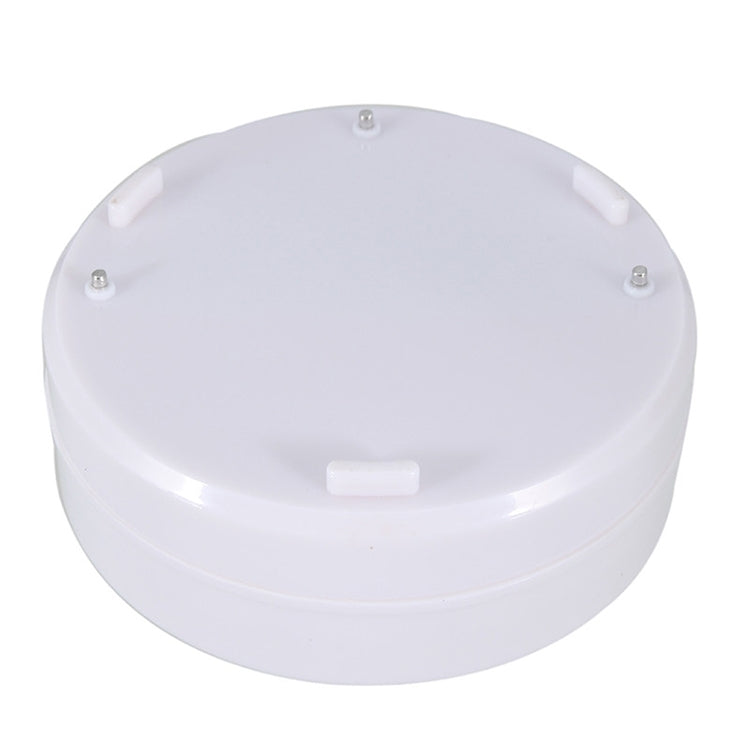 Round white water leak alarm sensor back with mounting screws and central button