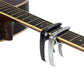 Silver guitar capo clamped to fretboard with curved locking arms