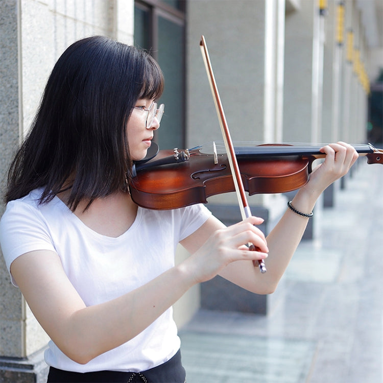 Acoustic violin with bow held by musician in white shirt