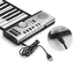 Roll-up electronic keyboard piano with speaker controls and attached charging cable