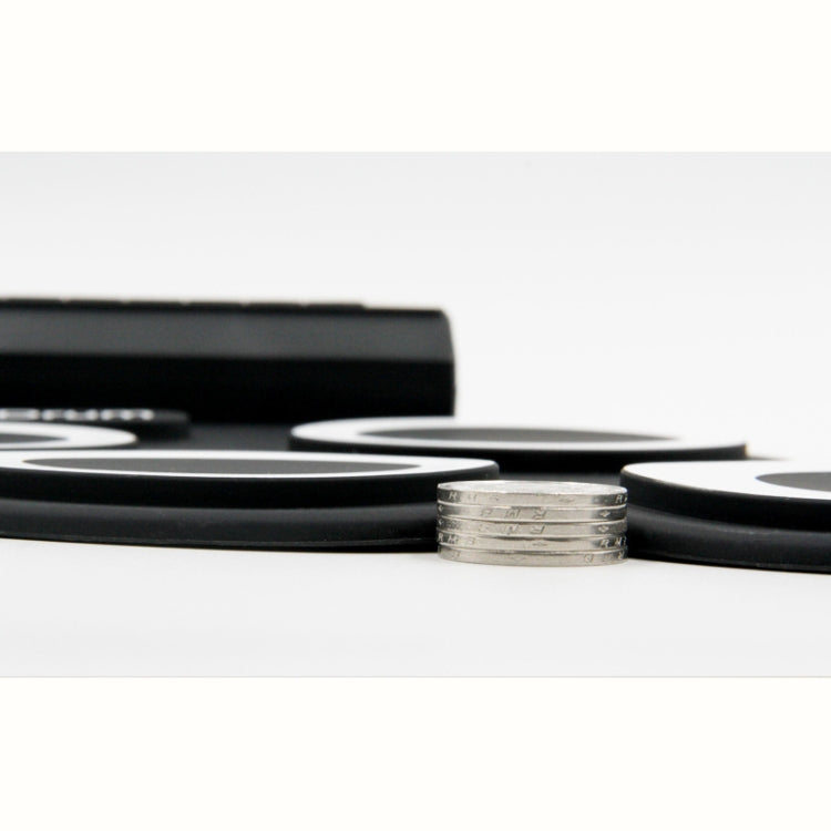 Close-up of black silicone electronic drum pads with raised circular striking surfaces