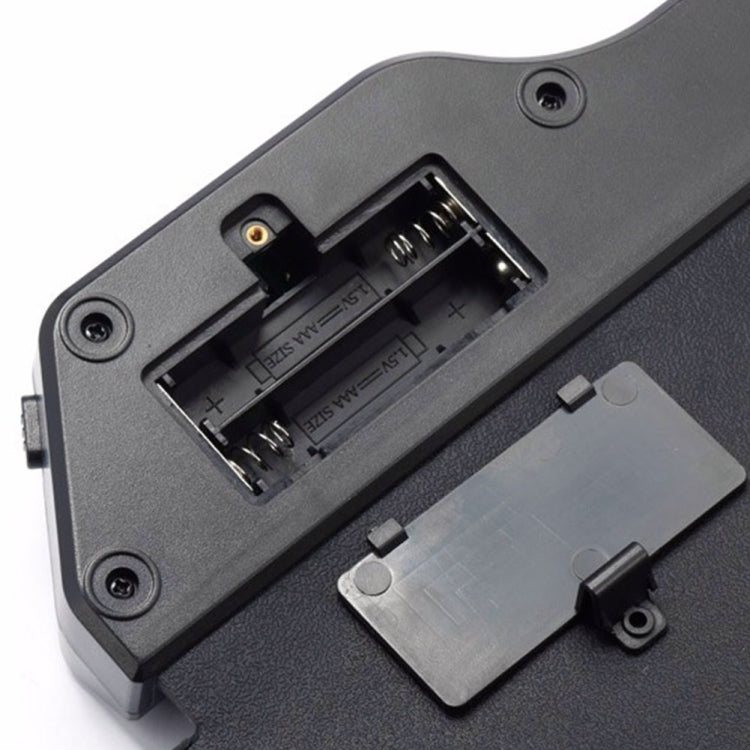 Black electronic drum open battery compartment with metal contacts and wiring slot