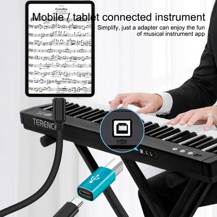 Blue Type-C to MIDI adapter connected to a keyboard controller with MIDI port